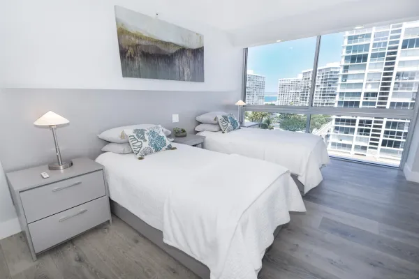 a spacious bedroom with a bed and a large window