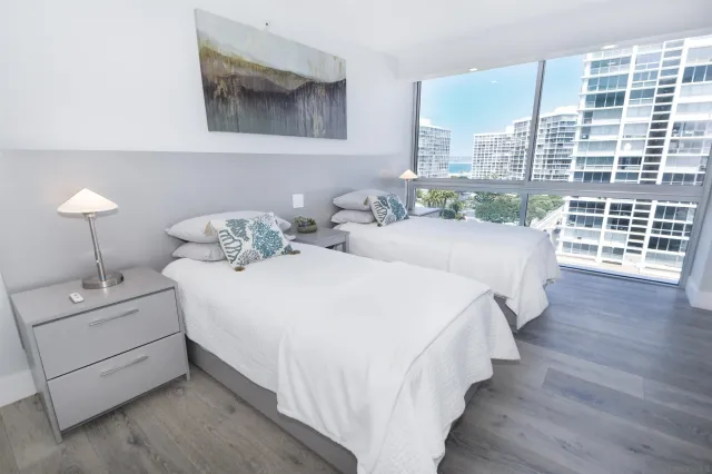 a spacious bedroom with a bed and a large window