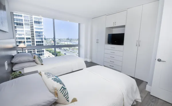 a bedroom with a bed and a television