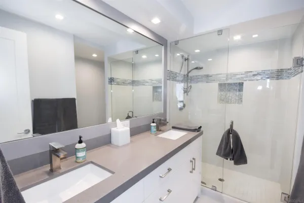 a kitchen with a sink and white cabinets