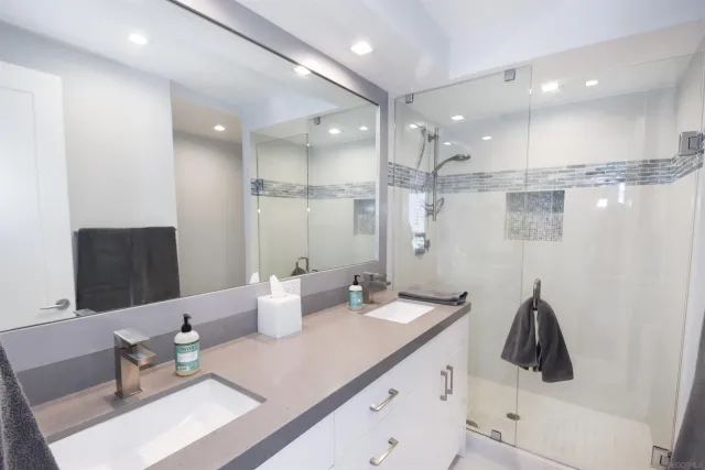 a kitchen with a sink and white cabinets