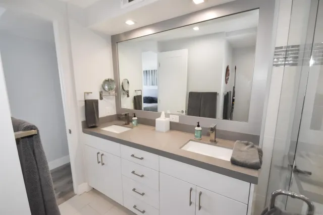 a bathroom with a double vanity sink and a mirror