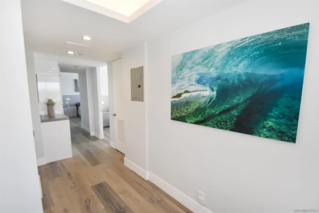 a view of a hallway with a view of bathroom