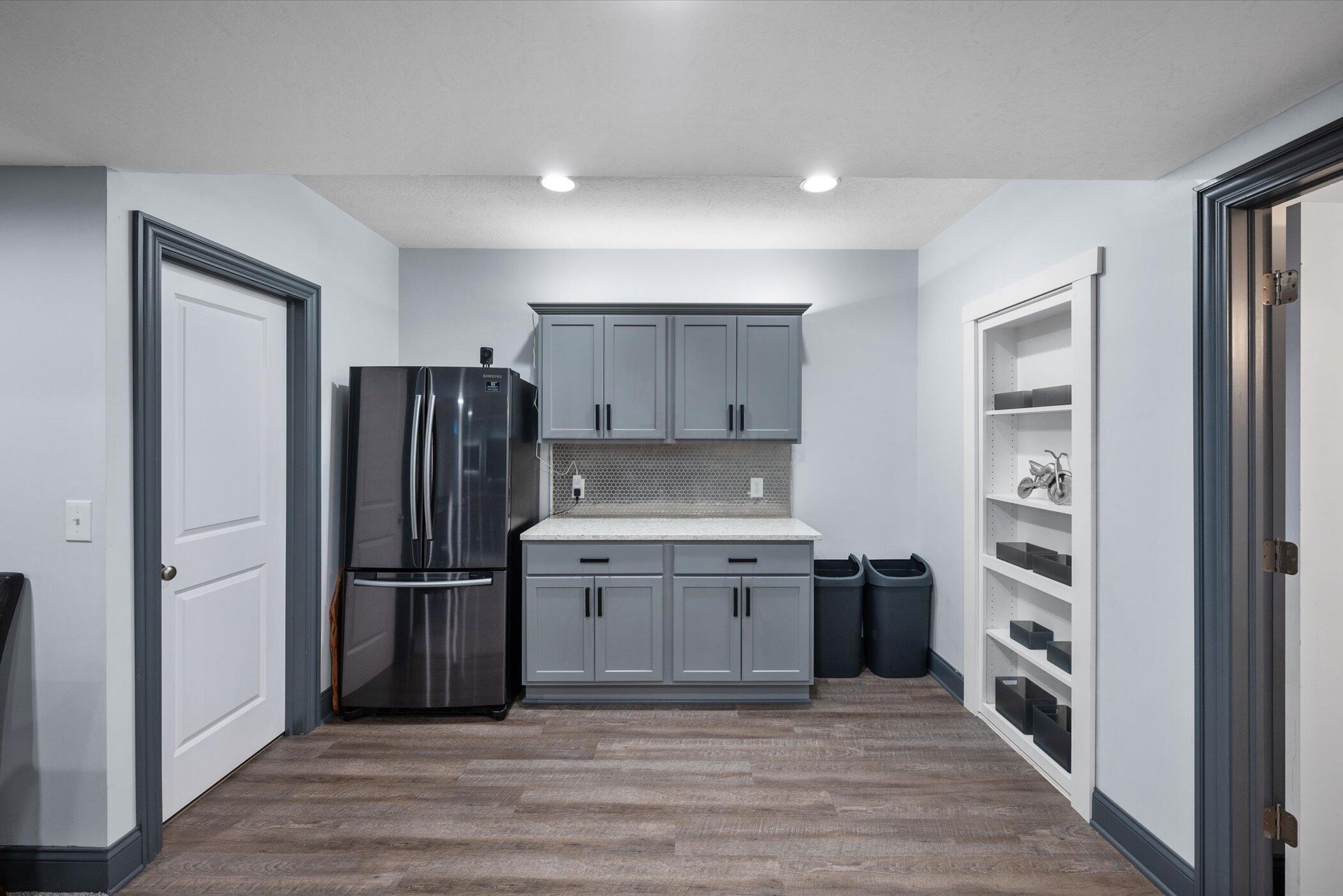 706 Bigham Ridge Boulevard Westerville, OH 43081 - Photo 48 of 62 Great area in the basement for fridge and movie snacks! Check out the secret door on the right!