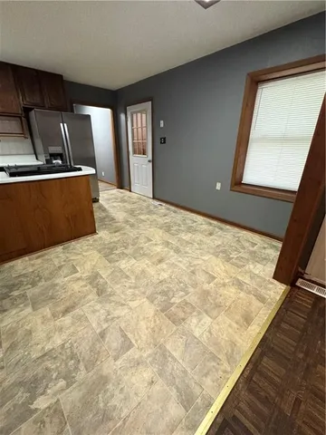 a bedroom with a bed and painting on the wall