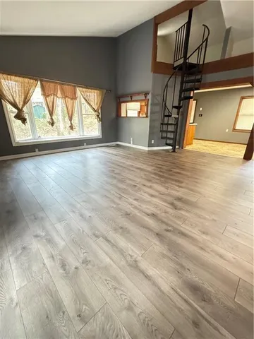 a view of wooden floor and a window in an empty room