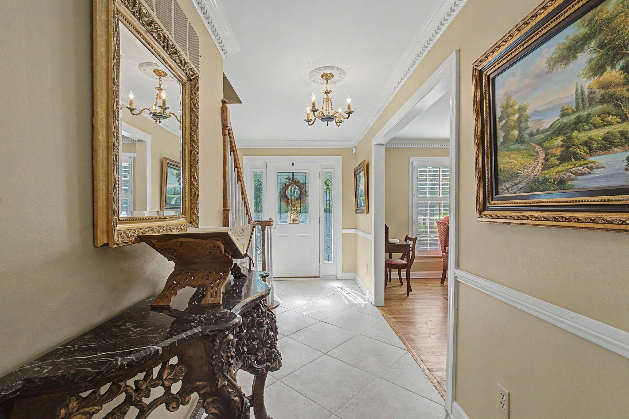 1929 Miller Farms Road Germantown, TN 38138 - Photo 5 of 40 Entryway featuring tile flooring, crown molding, a decorative front door with side paneling, and an overhead chandelier