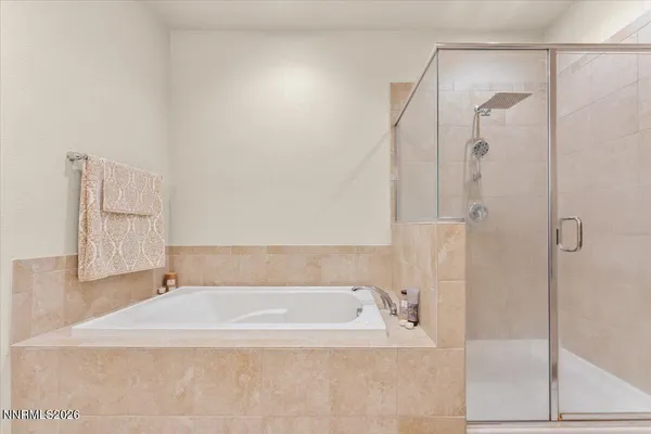 a white bath tub sitting next to a shower