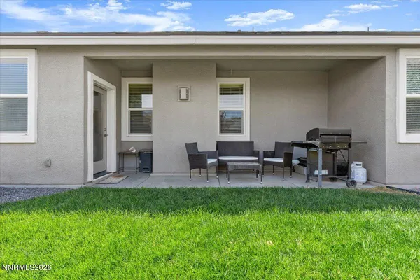 a view of a house with patio and a garden
