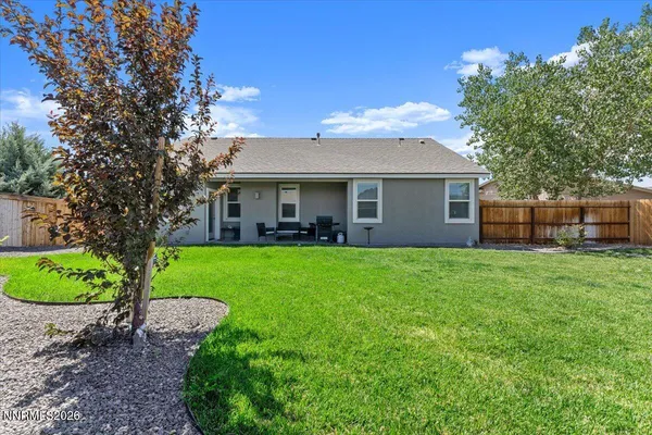 a front view of house with yard and outdoor seating