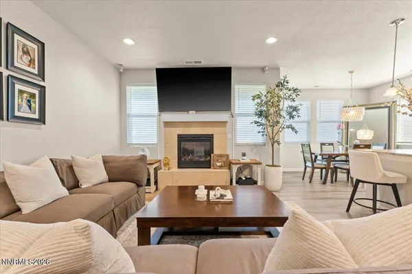 a living room with furniture a fireplace and a flat screen tv