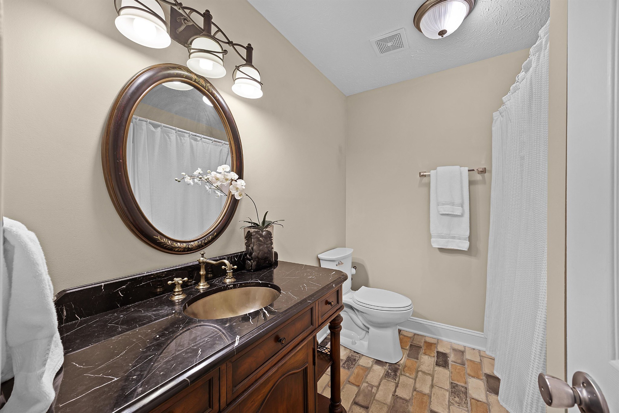 40 Vantage Pointe Counce, TN 38326 - Photo 14 of 25 a bathroom with a granite countertop toilet a sink and a mirror