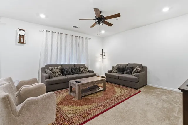 a living room with furniture and a rug