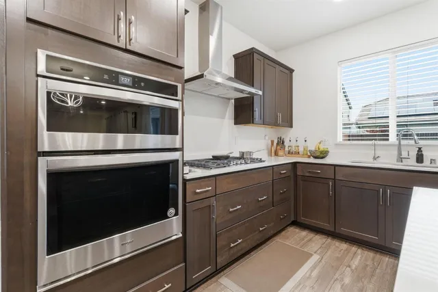 a kitchen with granite countertop cabinets stainless steel appliances and window