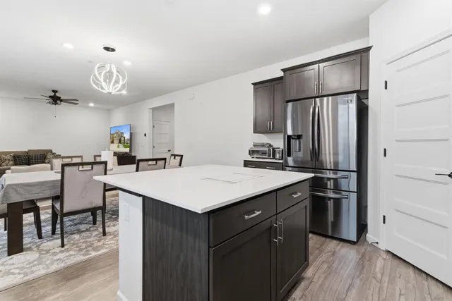 a kitchen with kitchen island a sink appliances and cabinets