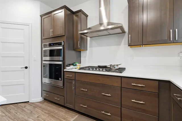 a kitchen with granite countertop cabinets and steel stainless steel appliances