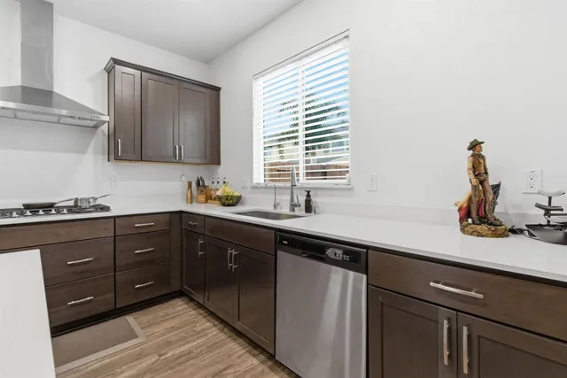 a kitchen with granite countertop cabinets sink and window