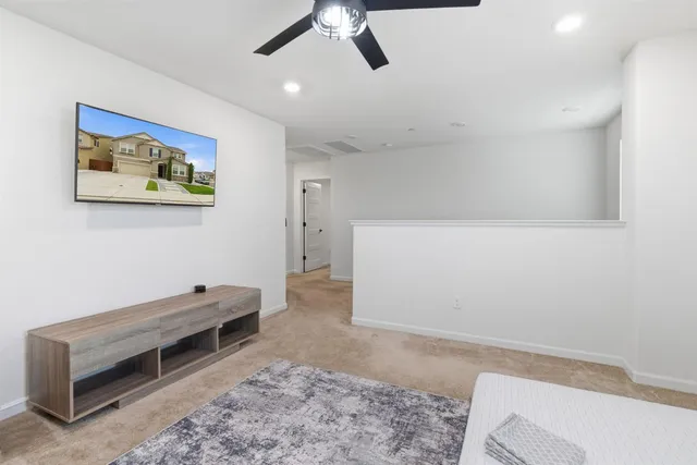 a spacious bedroom with a bed a couch and a window