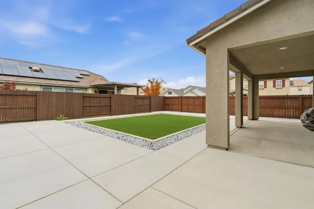 a kitchen with stainless steel appliances a stove a sink dishwasher and a refrigerator with wooden floor