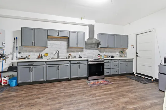 a front view of a house with a yard and potted plants