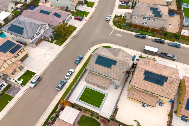 an aerial view of residential houses with outdoor space