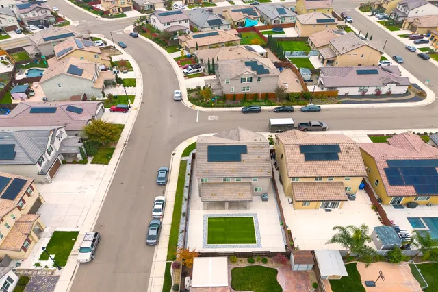 an aerial view of residential houses with outdoor space