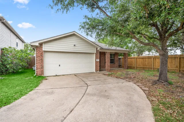 front view of a house with a yard and an trees