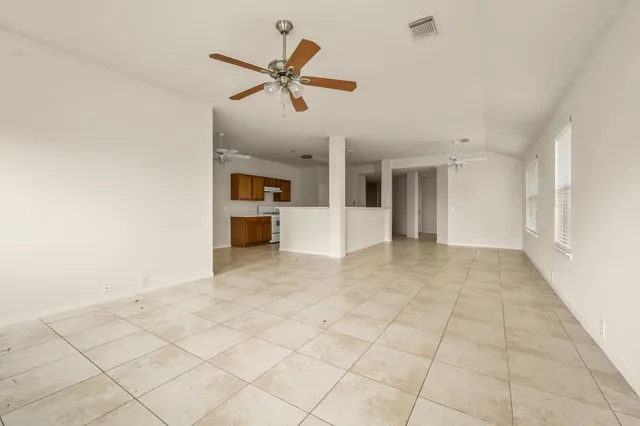 a view of a livingroom with a ceiling fan and window
