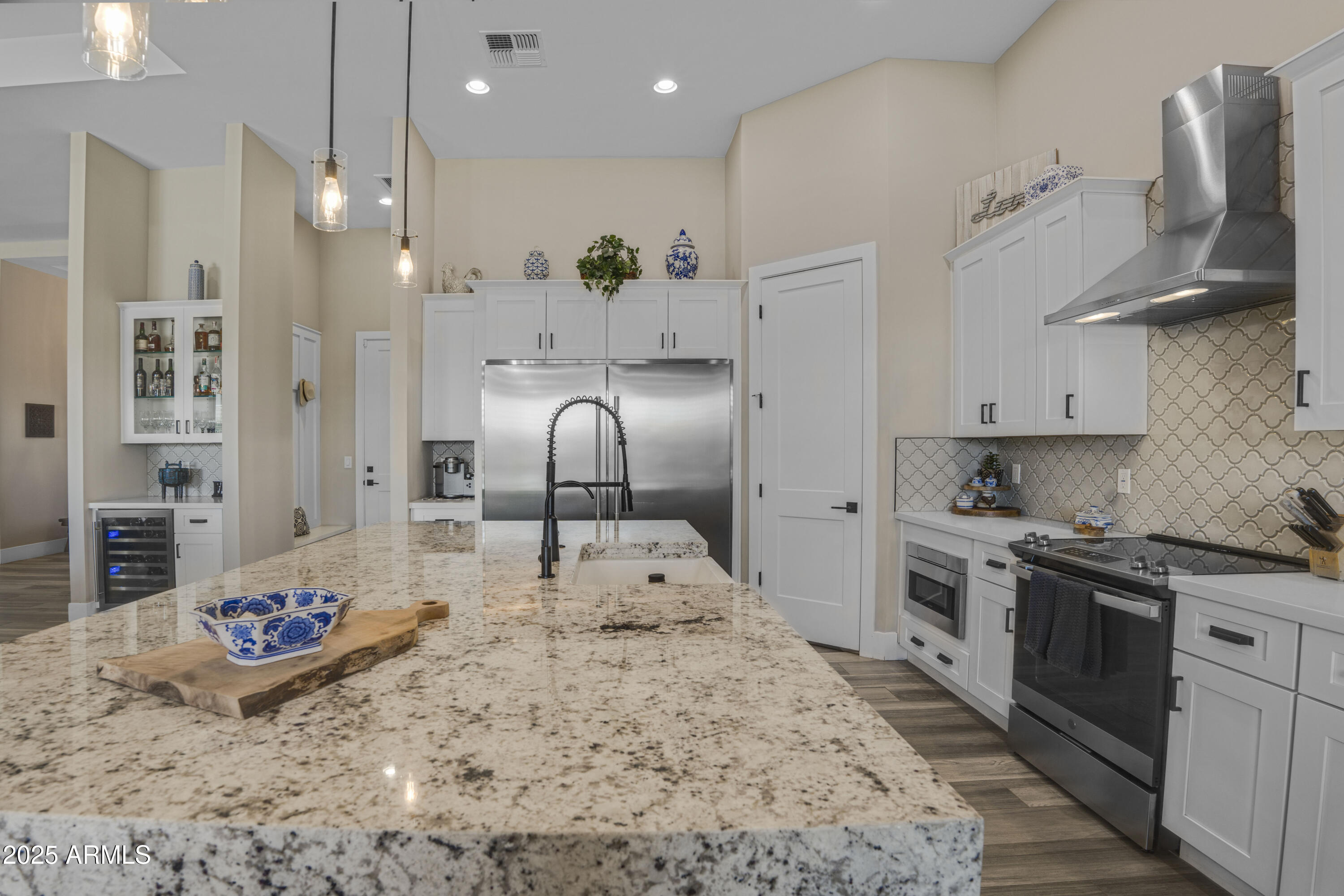 1011 West Carlise Road Phoenix, AZ 85086 - Photo 6 of 33 a kitchen with stainless steel appliances kitchen island granite countertop a sink dishwasher stove and refrigerator