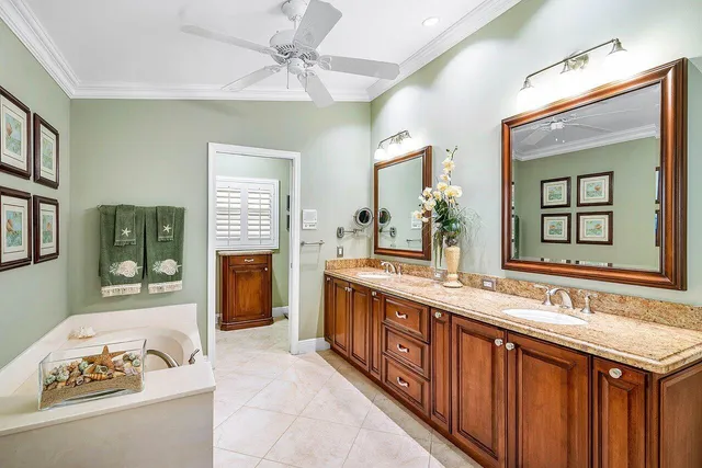 a spacious bathroom with a granite countertop tub sink and mirror