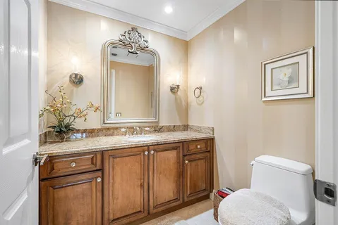 a bathroom with a toilet sink and mirror