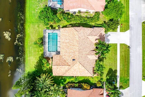 an aerial view of a house with a yard