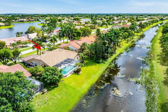 an aerial view of a house with a lake view