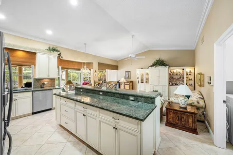 a kitchen with stainless steel appliances granite countertop a sink and a refrigerator