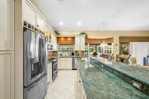 a kitchen with a refrigerator and a sink