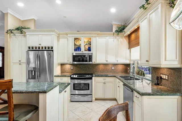 a kitchen with a sink stove and refrigerator