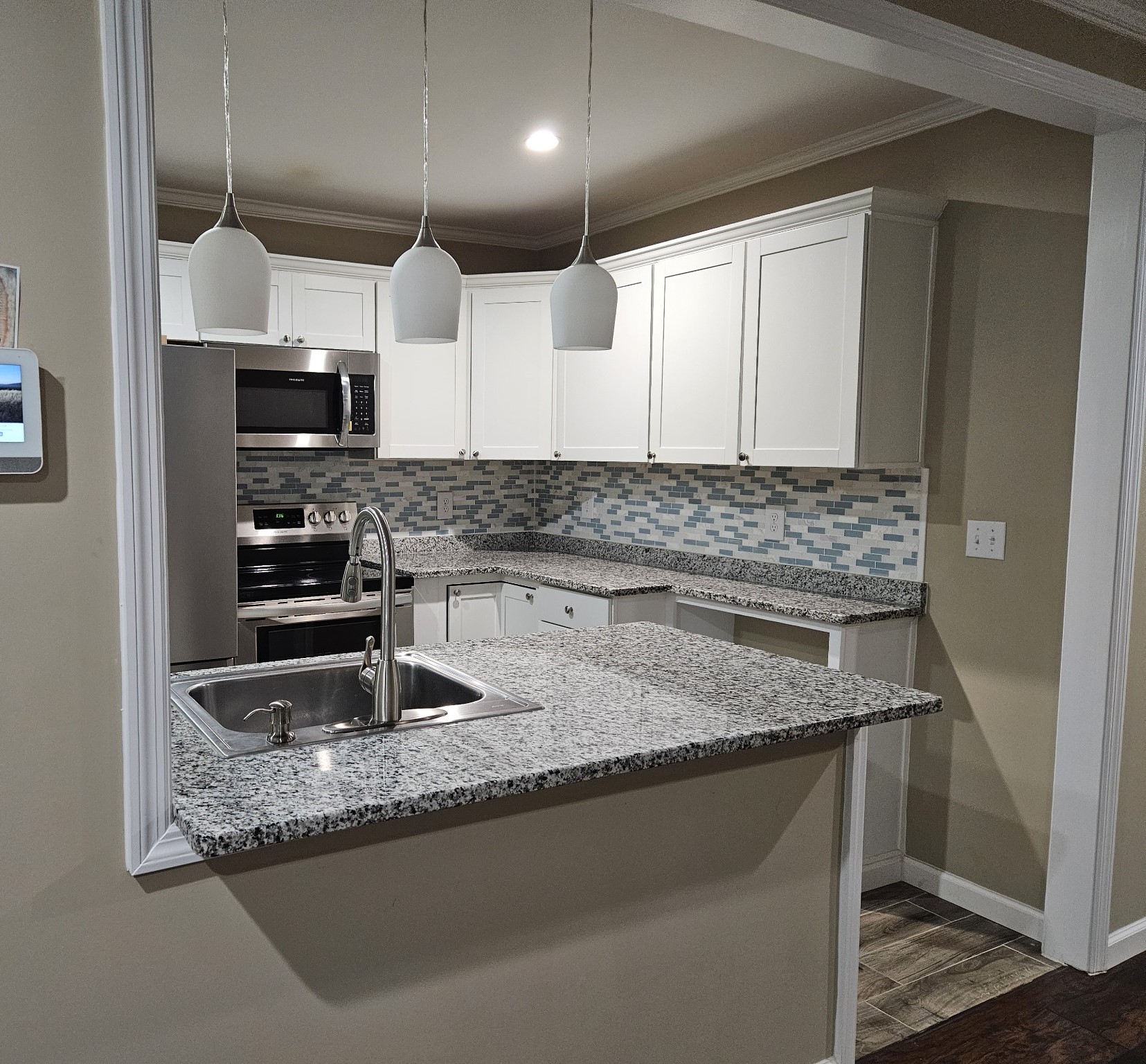 a kitchen with stainless steel appliances granite countertop a sink a stove and a refrigerator