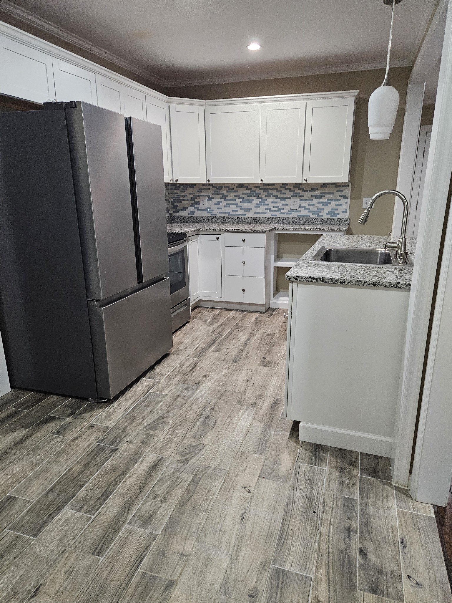 107 Gentry Street Tullahoma, TN 37388 - Photo 2 of 34 a kitchen with a refrigerator sink and cabinets