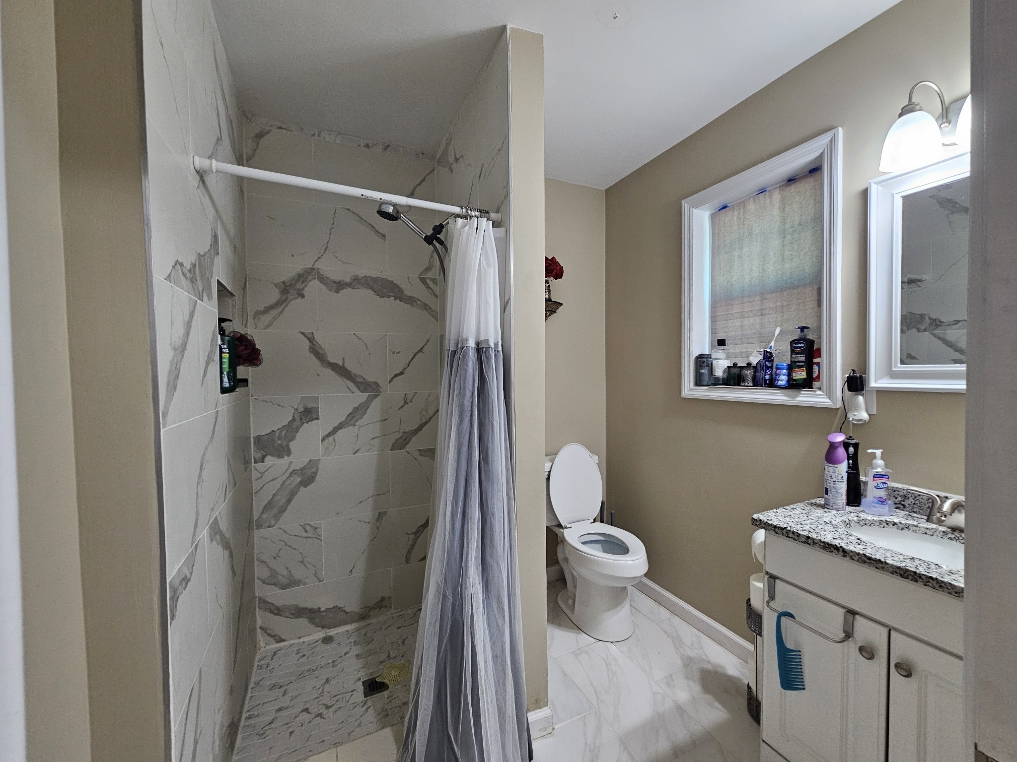 107 Gentry Street Tullahoma, TN 37388 - Photo 21 of 34 a bathroom with a granite countertop sink toilet and shower