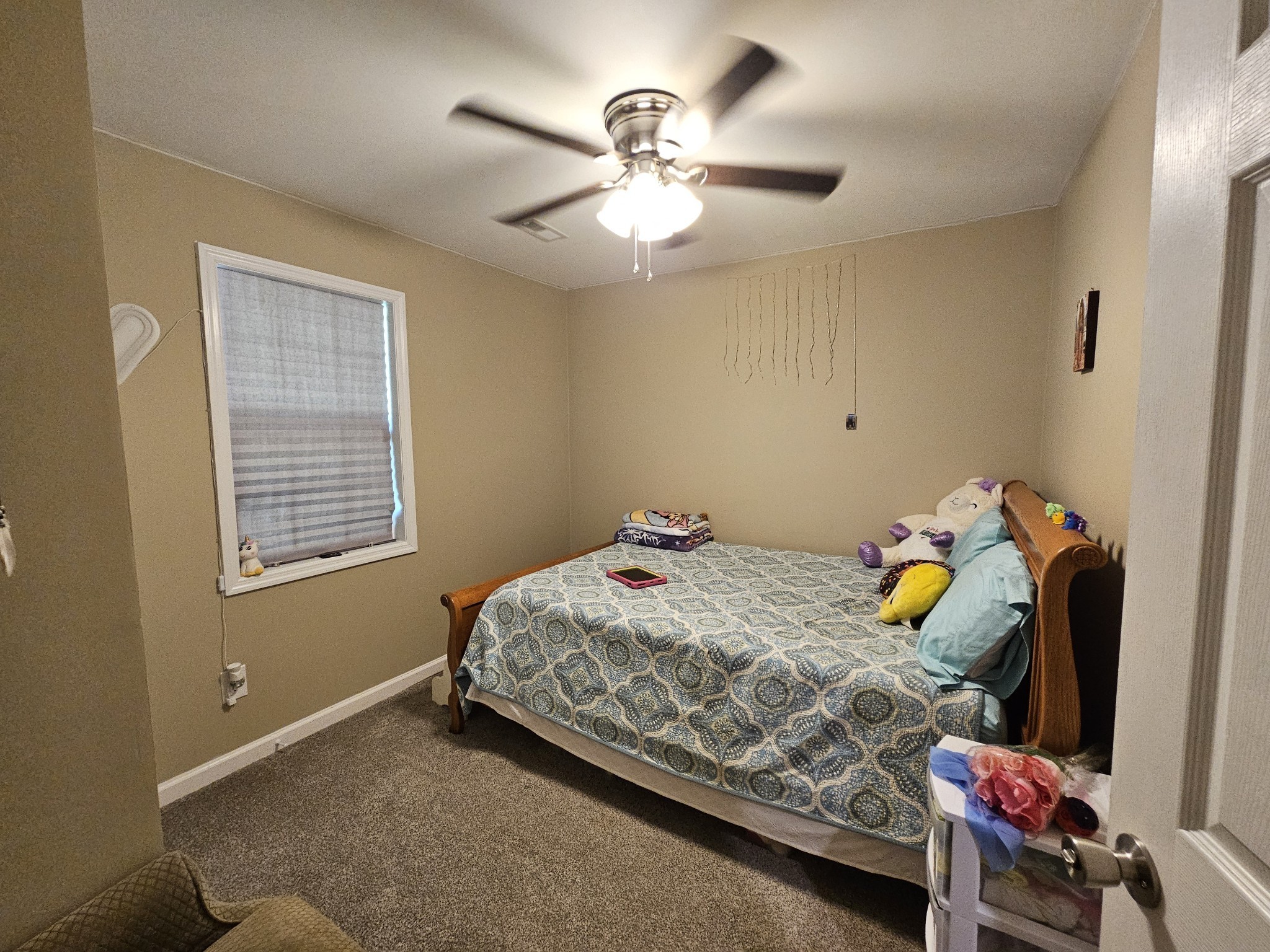 107 Gentry Street Tullahoma, TN 37388 - Photo 23 of 34 a bedroom with a bed and a chandelier
