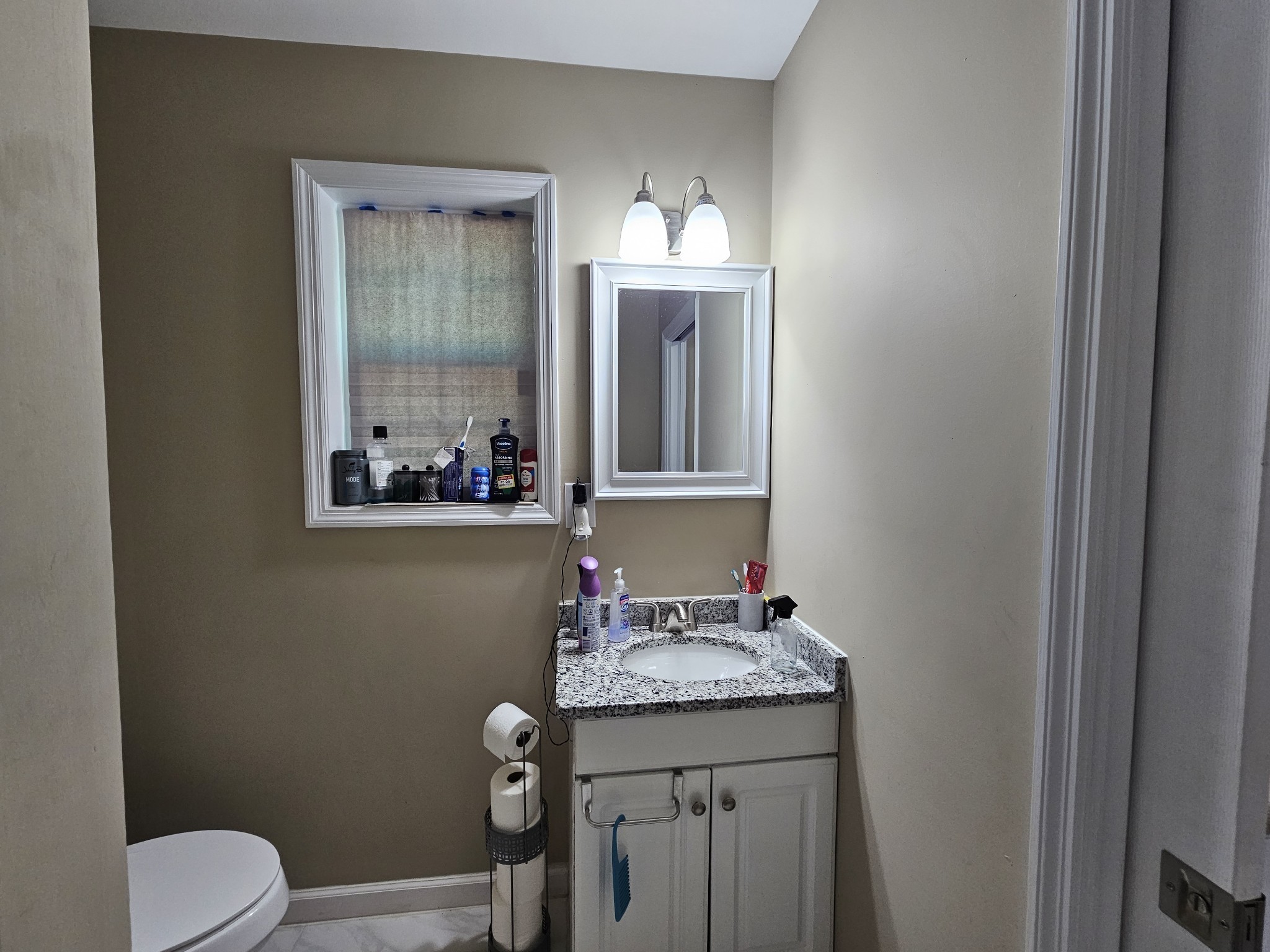 107 Gentry Street Tullahoma, TN 37388 - Photo 30 of 34 a bathroom with a granite countertop toilet sink and mirror