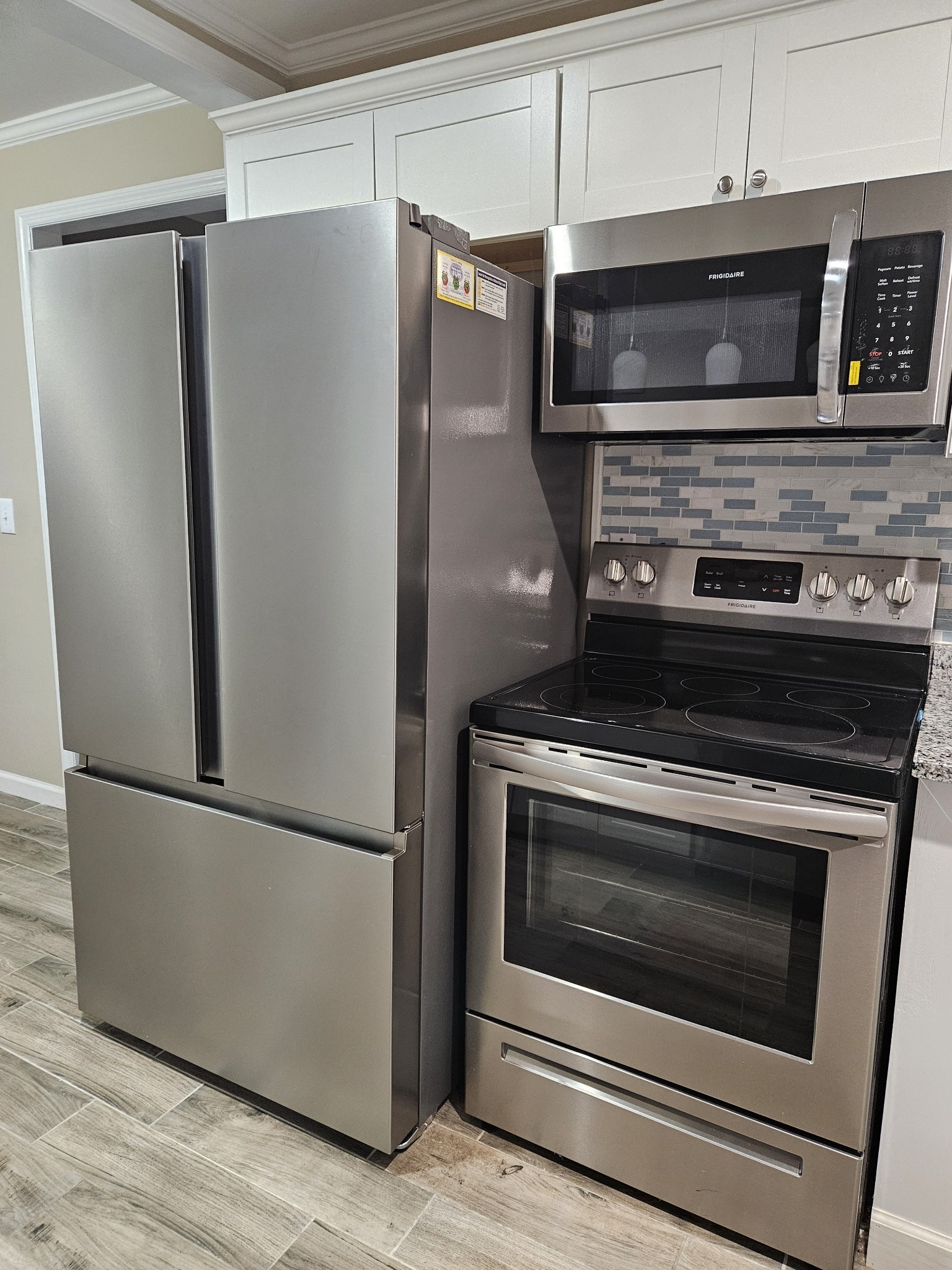 107 Gentry Street Tullahoma, TN 37388 - Photo 3 of 34 a kitchen with granite countertop stainless steel appliances and wooden cabinets