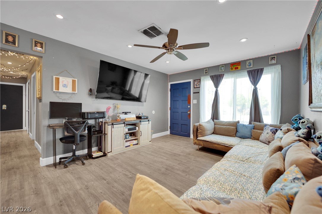 2221 Englestad Street North Las Vegas, NV 89030 - Photo 6 of 32 A welcoming living area with ample natural light and durable flooring for daily living.