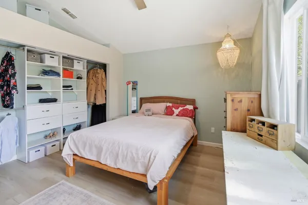 a bedroom with a bed and cabinet