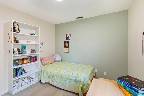 a bedroom with a bed and dresser