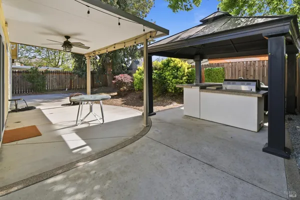 a view of a patio with a table and chairs