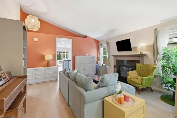 a living room with furniture a fireplace and a flat screen tv