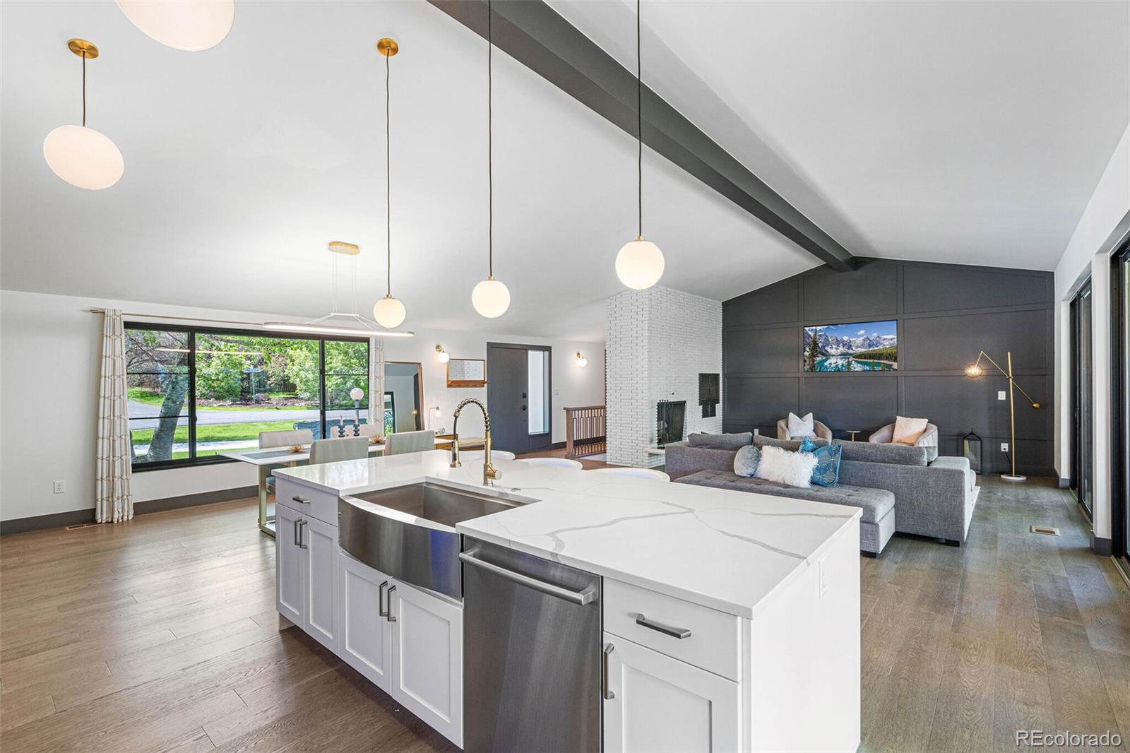 17 Rangeview Drive Wheat Ridge, CO 80215 - Photo 15 of 50 a large kitchen with kitchen island a large island attached withe living room