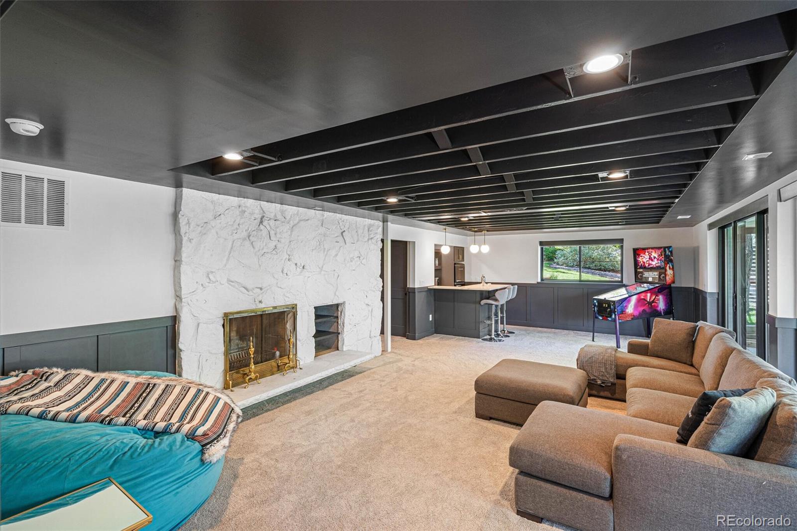 17 Rangeview Drive Wheat Ridge, CO 80215 - Photo 27 of 50 a living room with furniture and a fireplace