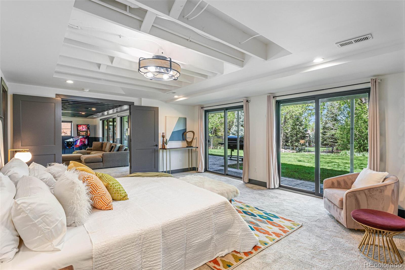 17 Rangeview Drive Wheat Ridge, CO 80215 - Photo 31 of 50 a spacious bedroom with a bed and glass windows